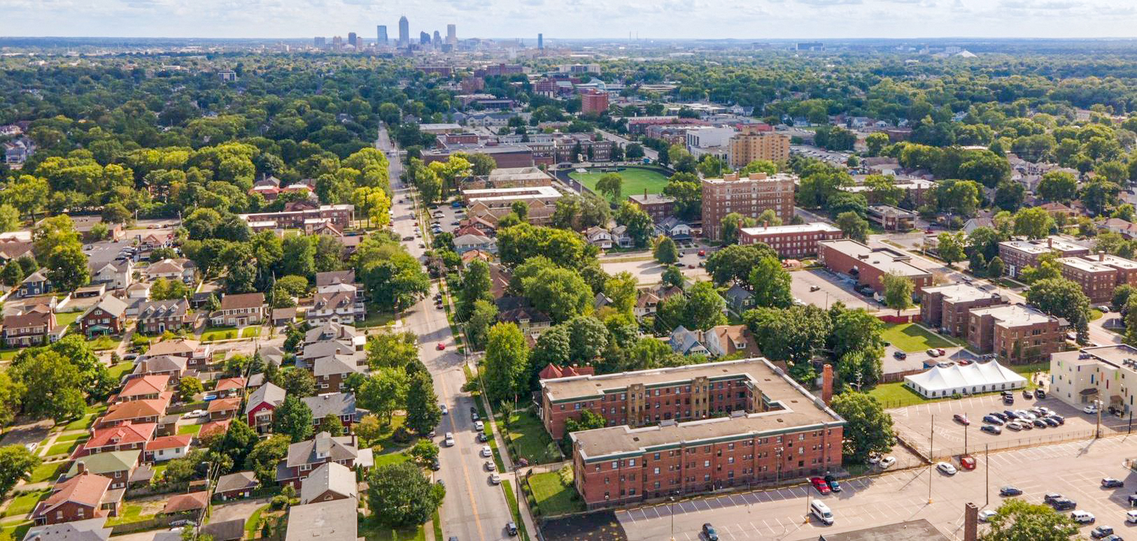 Aerial photo of at Historic Dorchester apartments with Indianapolis skyline on the horizon.